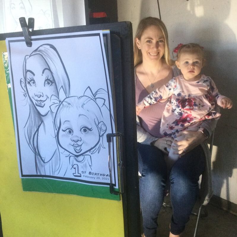 Northern California caricaturist JAGuerzon entertains a mom and daughter with cartoon caricatures at a birthday event in Antioch, California.
